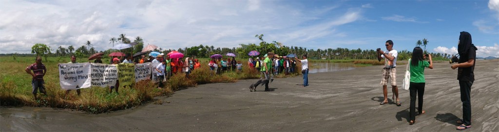 MacArthur townspeople with other civil society members and partners of Alyansa Tigil Mina hold a rally in front of an illegal black sand mining site in Maya village on August 21.